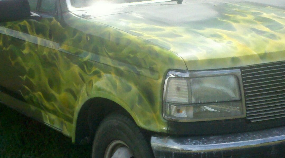 Multiple green and yellow flames on truck hood