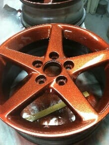 Orange copper metal flakes on a wheel