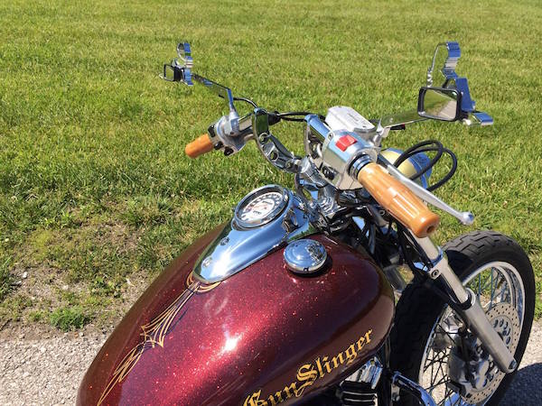 Close up of Gunslinger bike with gold metal flake kustom paint.
